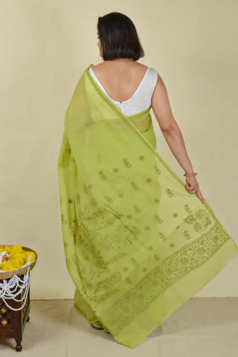 Handcrafted Green Cotton Saree with intricate Lucknowi Chikankari embroidery and a matching blouse, ideal for festive and wedding occasions.