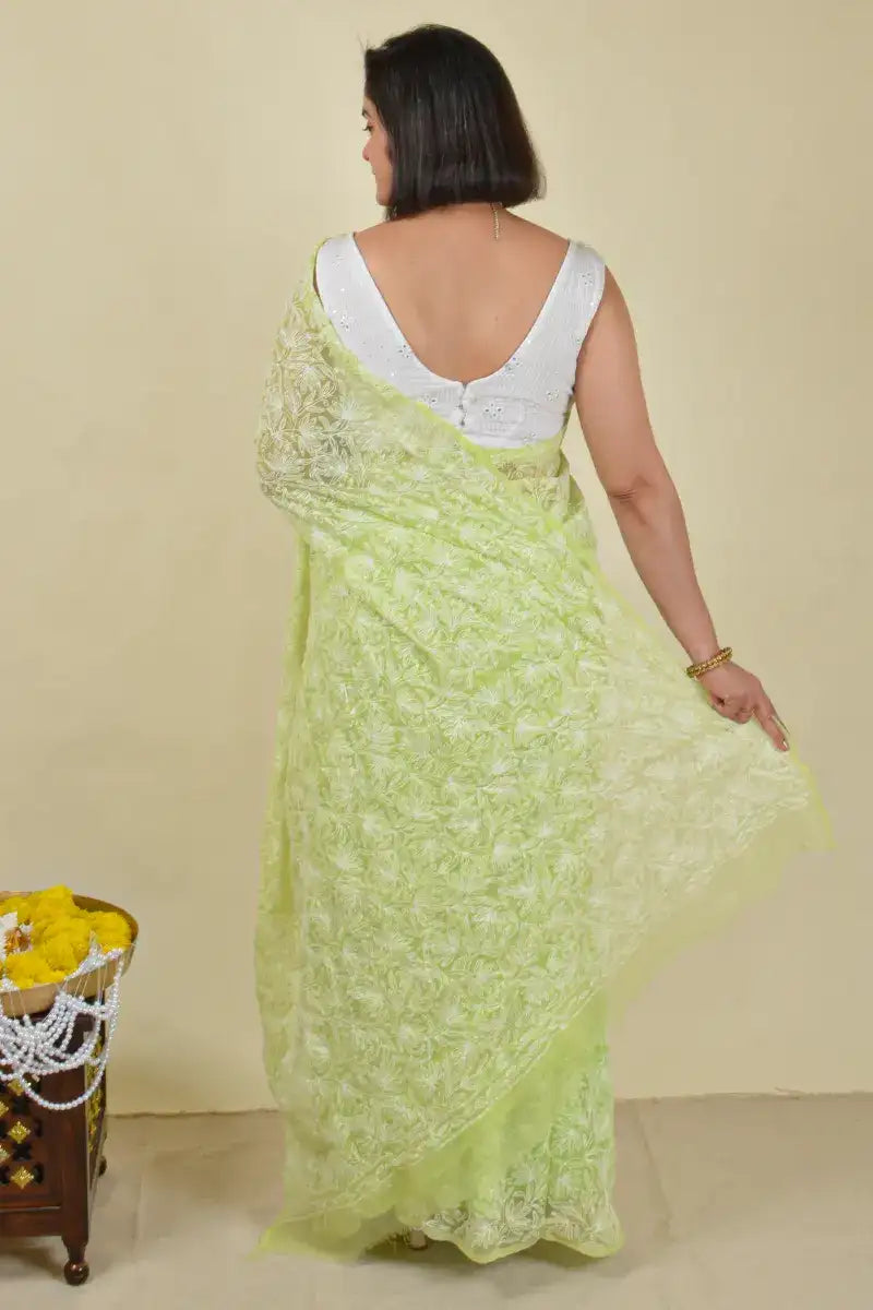 Handcrafted Green Georgette Saree with intricate Lucknowi Mukaish
Tepchi Chikankari embroidery and a matching blouse, ideal for festive and wedding occasions.