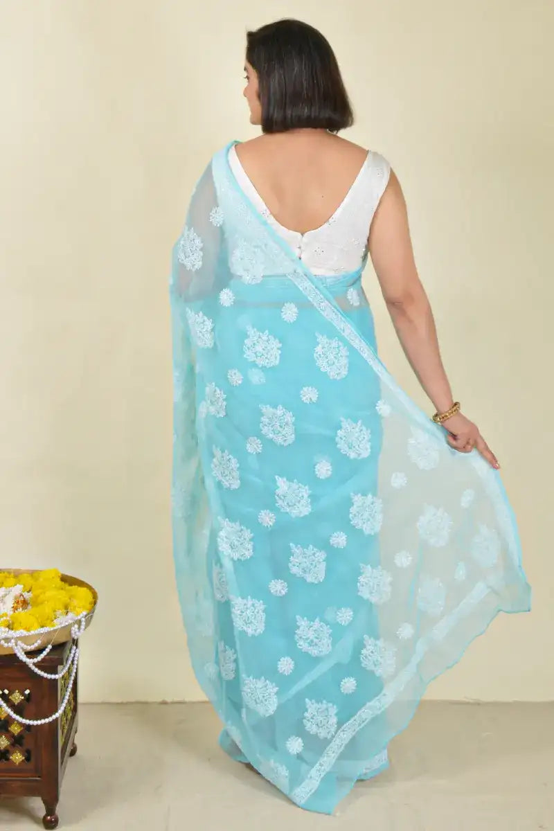 Handcrafted Sky Blue Georgette Saree with intricate Lucknowi Chikankari embroidery and a matching blouse, ideal for Festive and wedding occasions.