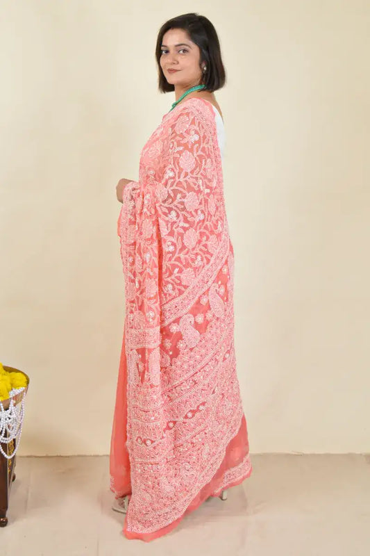 Handcrafted Orange saree with intricate Lucknowi Chikankari embroidery and a matching blouse, ideal for festive and wedding occasions.