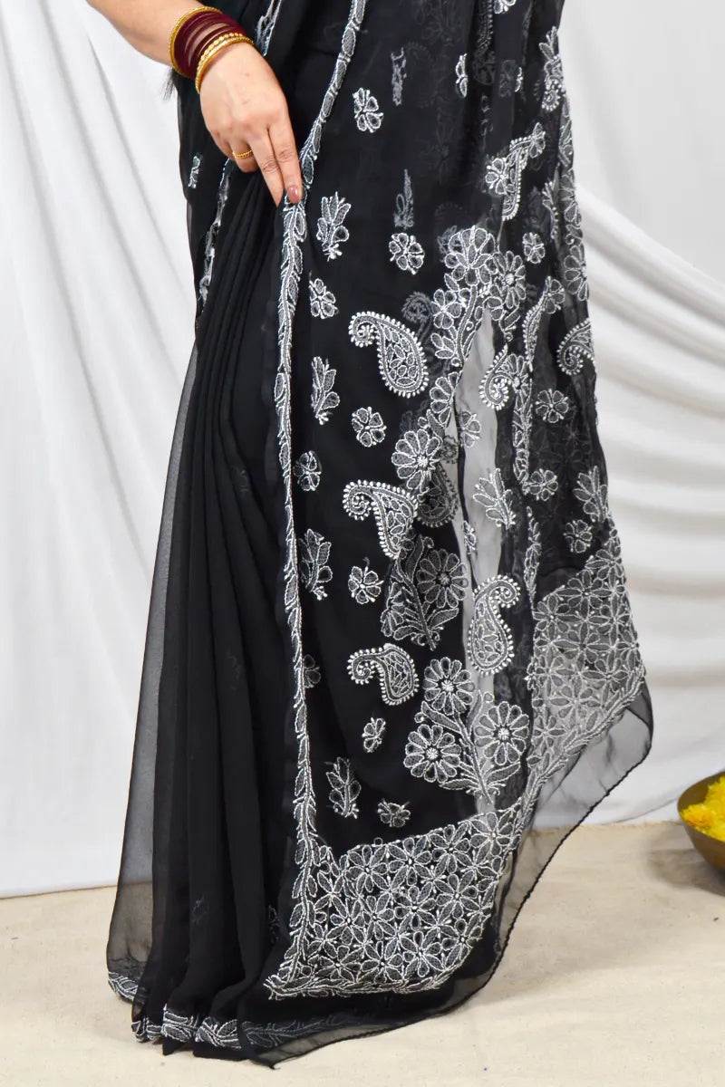 Handcrafted Black Georgette saree intricate Lucknowi Chikankari embroidery and a matching blouse, ideal for festive and wedding occasions.
