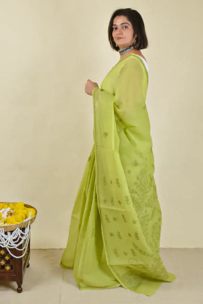 Handcrafted Green Cotton Saree with intricate Lucknowi Chikankari embroidery and a matching blouse, ideal for festive and wedding occasions.