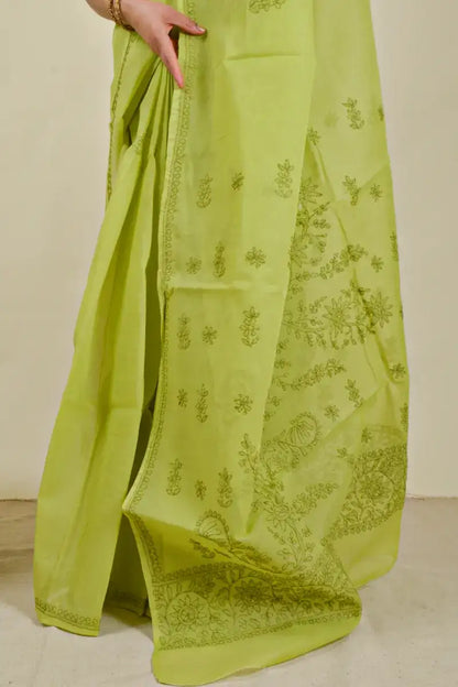 Handcrafted Green Cotton Saree with intricate Lucknowi Chikankari embroidery and a matching blouse, ideal for festive and wedding occasions.