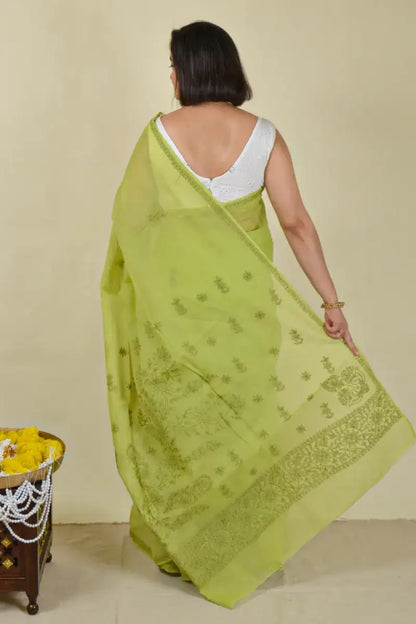 Handcrafted Green Cotton Saree with intricate Lucknowi Chikankari embroidery and a matching blouse, ideal for festive and wedding occasions.