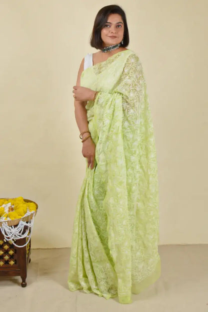 Handcrafted Green Georgette Saree with intricate Lucknowi Mukaish 
 Tepchi Chikankari embroidery and a matching blouse, ideal for festive and wedding occasions.