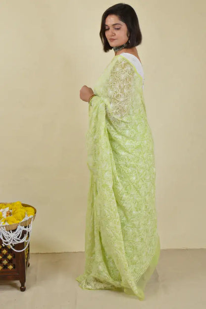 Handcrafted Green Georgette Saree with intricate Lucknowi Mukaish 
 Tepchi Chikankari embroidery and a matching blouse, ideal for festive and wedding occasions.