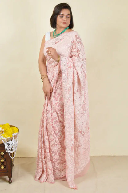 Handcrafted Peach Georgette Saree with intricate Lucknowi Mukaish work Chikankari embroidery and a matching blouse, ideal for festive and wedding occasions.