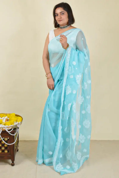Handcrafted Sky Blue Georgette Saree with intricate Lucknowi Chikankari embroidery and a matching blouse, ideal for Festive and wedding occasions.