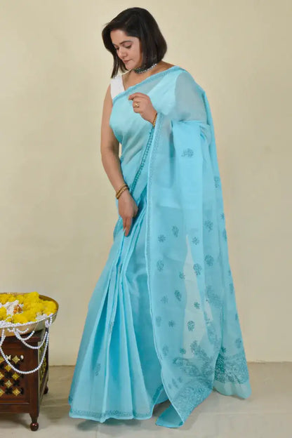 Handcrafted Blue Cotton saree with intricate Lucknowi Chikankari embroidery and a matching blouse, ideal for festive and wedding occasions.