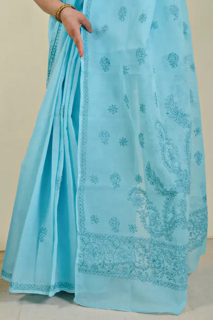 Handcrafted Blue Cotton saree with intricate Lucknowi Chikankari embroidery and a matching blouse, ideal for festive and wedding occasions.