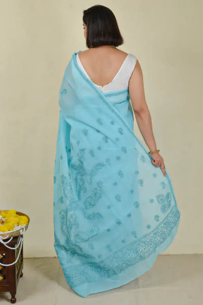 Handcrafted Blue Cotton saree with intricate Lucknowi Chikankari embroidery and a matching blouse, ideal for festive and wedding occasions.