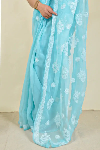 Handcrafted Sky Blue Georgette Saree with intricate Lucknowi Chikankari embroidery and a matching blouse, ideal for Festive and wedding occasions.