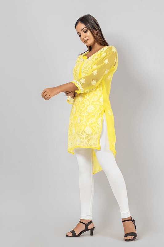 Fabnuma Handcrafted Chikankari Yellow Georgette Short Top with intricate white embroidery on model.