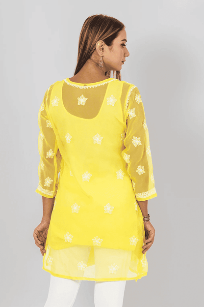 Fabnuma Handcrafted Chikankari Yellow Georgette Short Top with white floral embroidery on sheer sleeves and back panel.