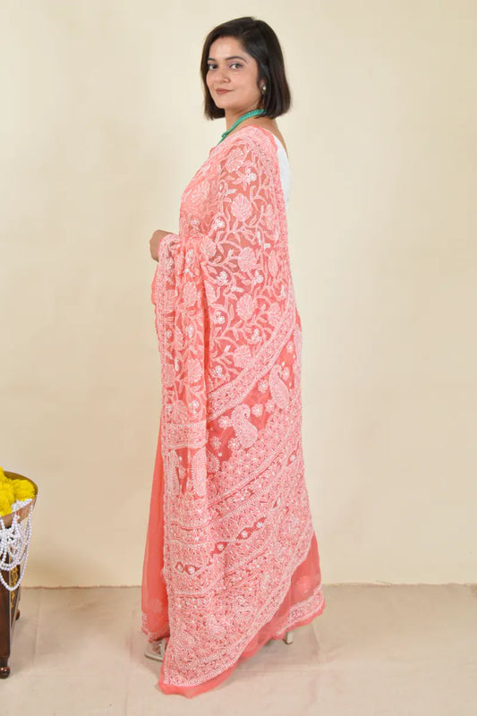 Handcrafted Orange saree with intricate Lucknowi Chikankari embroidery and a matching blouse, ideal for festive and wedding occasions.