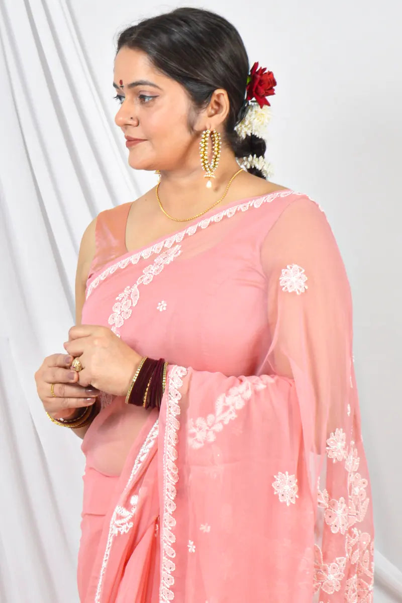 Handcrafted Peach Georgette saree with Muakish intricate Lucknowi Chikankari embroidery and a matching blouse, ideal for festive and wedding occasions.
