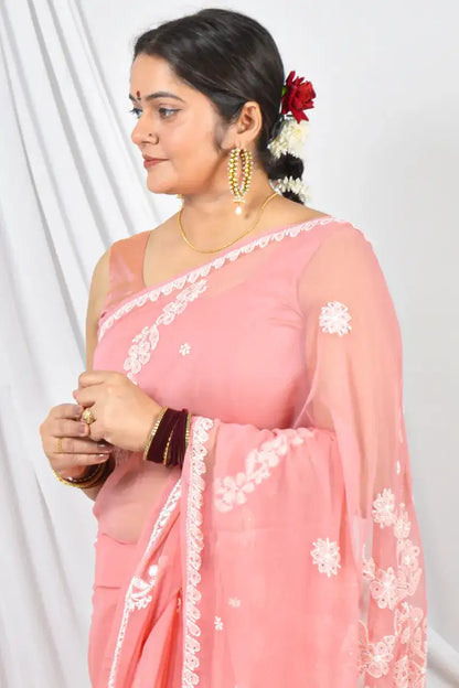 Handcrafted Peach Georgette saree with Muakish intricate Lucknowi Chikankari embroidery and a matching blouse, ideal for festive and wedding occasions.
