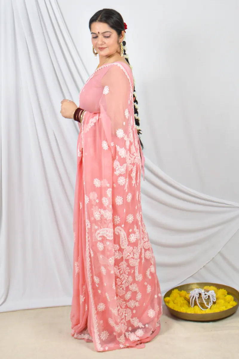 Handcrafted Peach Georgette saree with Muakish intricate Lucknowi Chikankari embroidery and a matching blouse, ideal for festive and wedding occasions.
