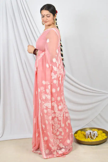 Handcrafted Peach Georgette saree with Muakish intricate Lucknowi Chikankari embroidery and a matching blouse, ideal for festive and wedding occasions.
