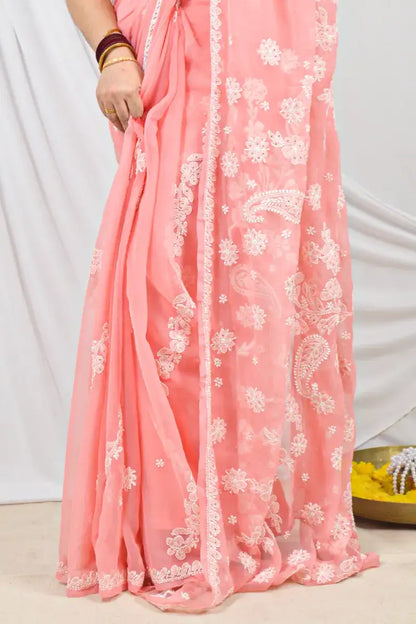 Handcrafted Peach Georgette saree with Muakish intricate Lucknowi Chikankari embroidery and a matching blouse, ideal for festive and wedding occasions.