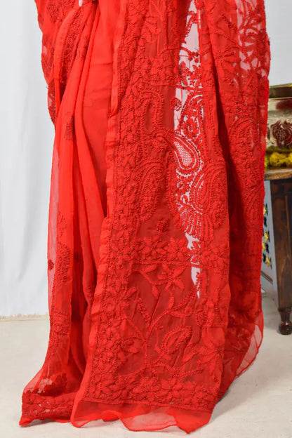 Red embroidered fabric with intricate patterns on a white background