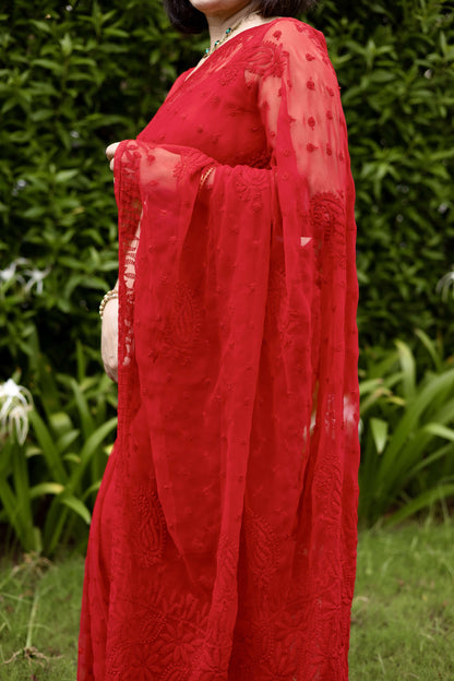 Side drape view of red georgette Lucknowi chikankari saree showing embroidery detail