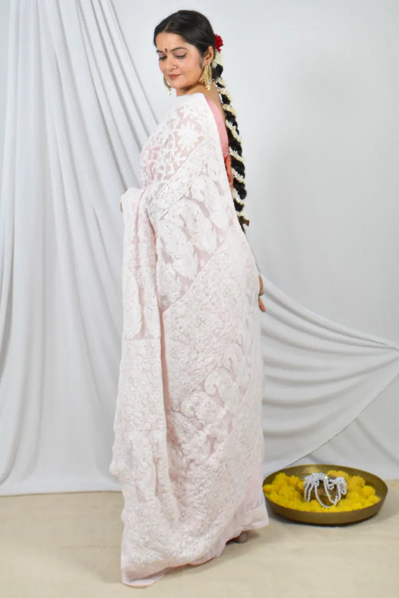 Handcrafted Dust Pink Georgette Saree with intricate Allover Lucknowi Chikankari with Muakish Embroidery and a matching blouse, ideal for festive and wedding occasions.