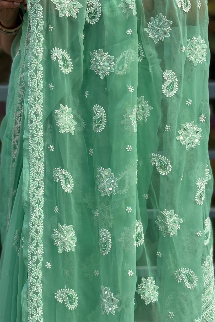 Pallu detail of MeMaana green georgette chikankari saree with fine handcrafted work