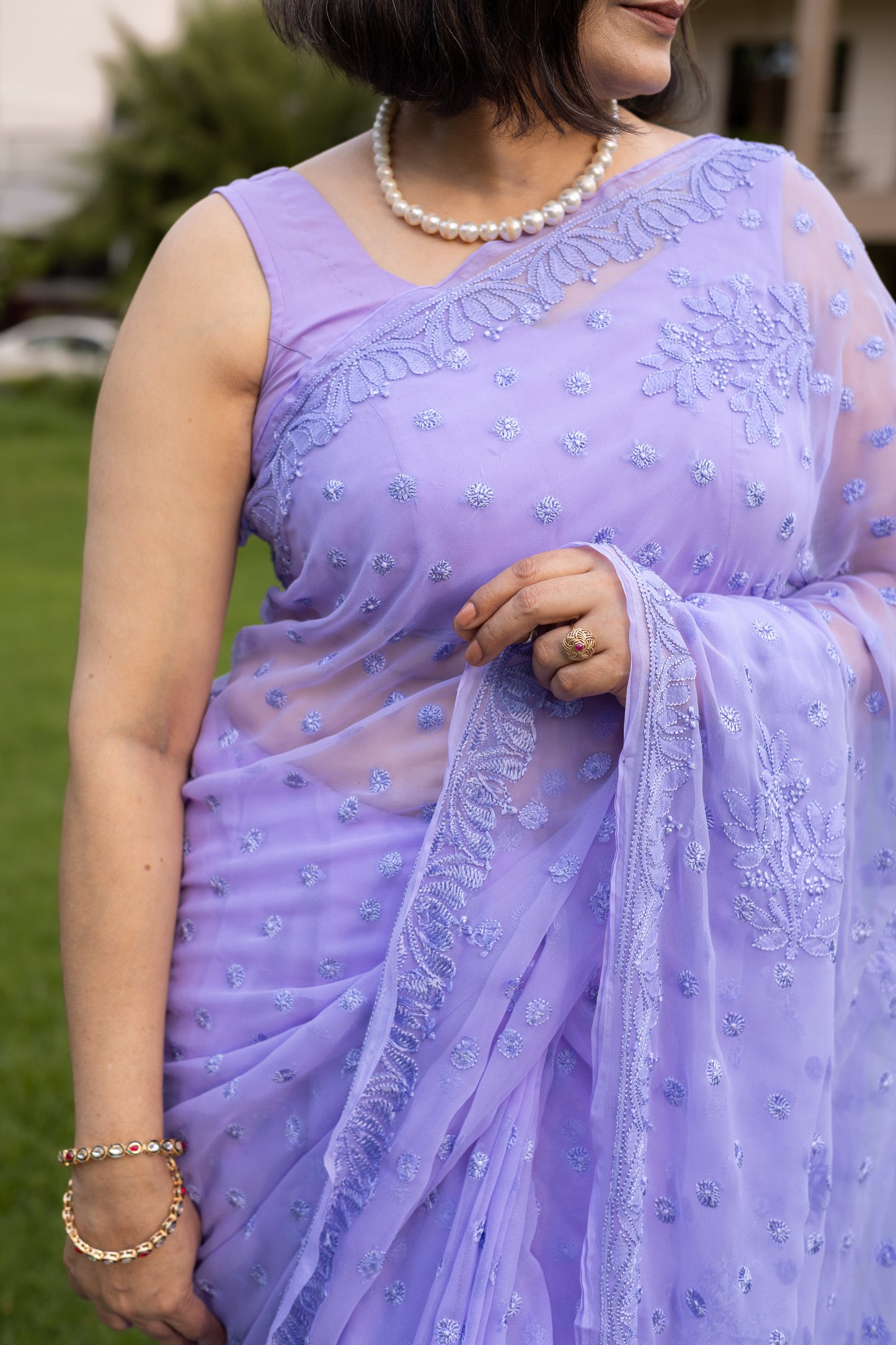 Close-up of lavender chikankari saree pallu embroidery with hand detail