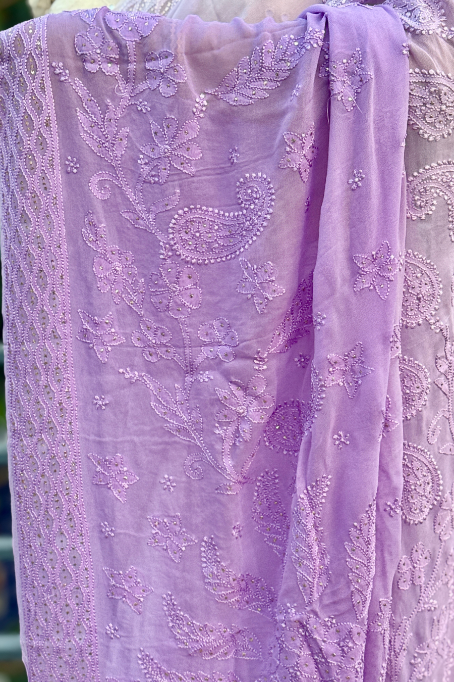 Close-up of lavender Viscose Georgette fabric showing handcrafted Lucknowi Chikankari with paisley, floral and murri embroidery with subtle mukaish work