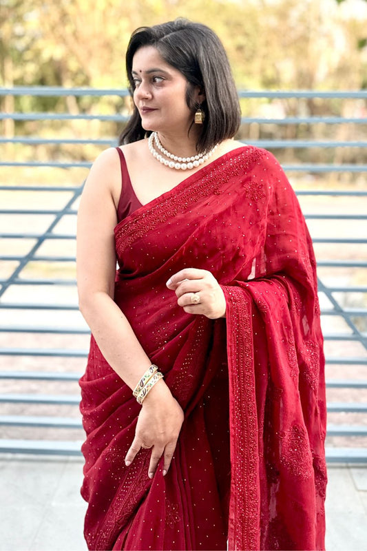Handcrafted Lucknowi chikankari and mukaish embroidery detail on red organza saree.