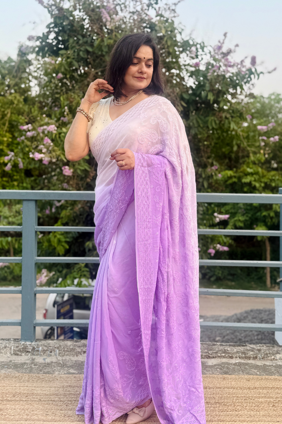 Side view of shaded lavender Chikankari saree showing soft georgette drape and all-over hand embroidery