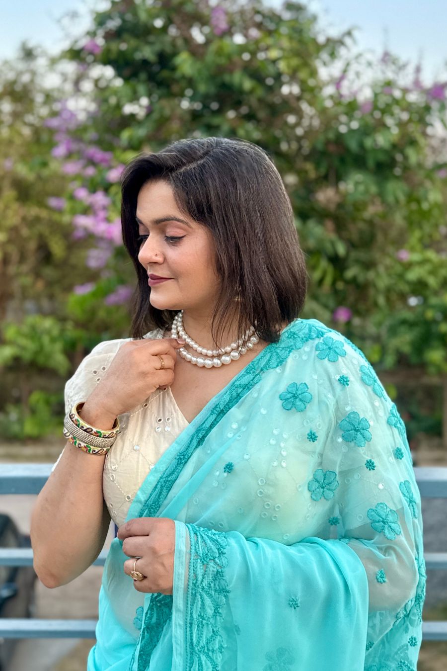 Elegant pastel chikankari saree styling with pearl jewelry
