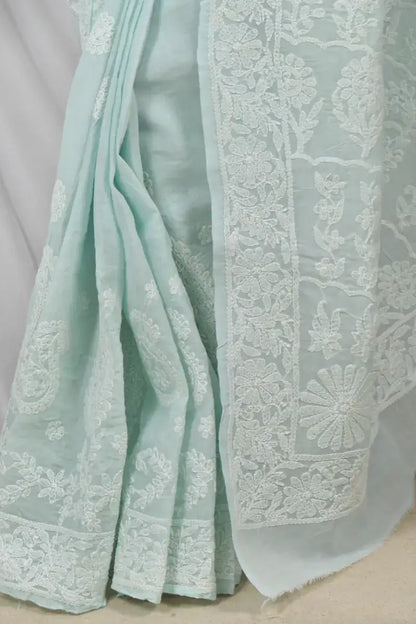Handcrafted Pestal Blue Cotton Designer saree with intricate Lucknowi Chikankari embroidery and a matching blouse, ideal for festive and wedding occasions.