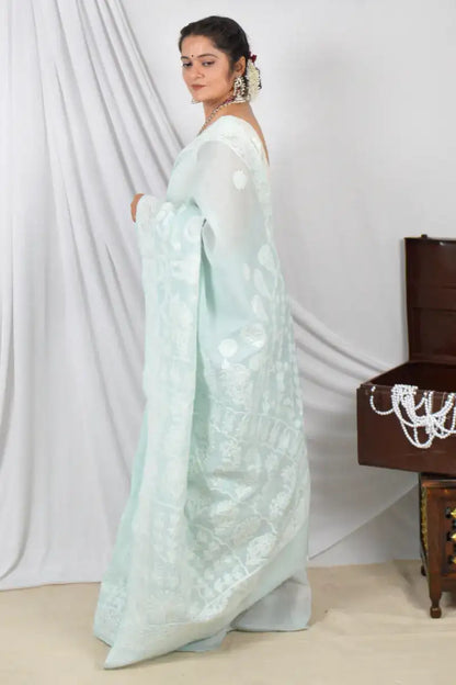 Handcrafted Pestal Blue Cotton Designer saree with intricate Lucknowi Chikankari embroidery and a matching blouse, ideal for festive and wedding occasions.