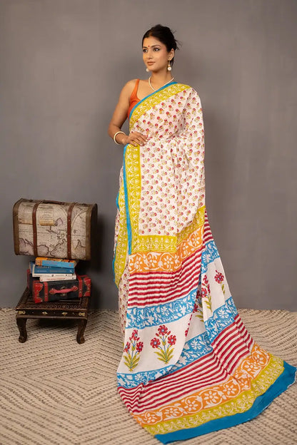 Woman wearing a colorful saree with a grey background
