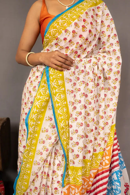 Woman wearing a colorful saree with a grey background