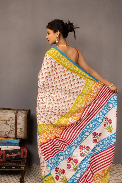 Woman wearing a colorful saree with a grey background